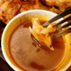 Dipping chicken into Chalet Sauce